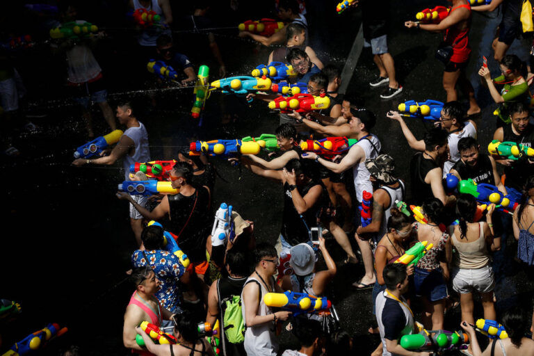 People play with water pistols during Songkran Water Festival to celebrate Thai New Year, in Bangkok